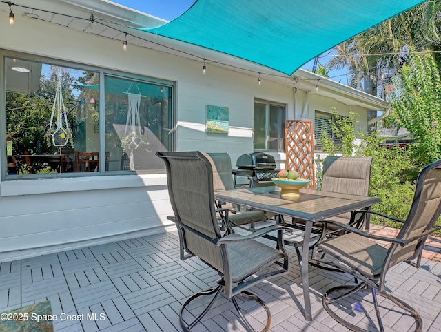 wooden deck featuring outdoor dining area and grilling area