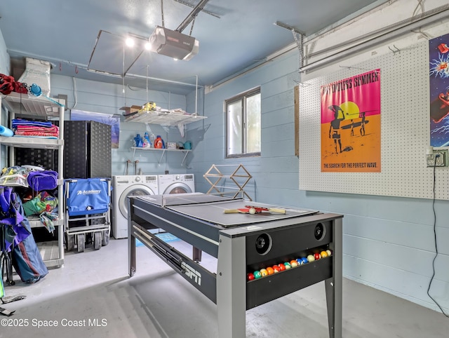 rec room with a garage, washing machine and dryer, and concrete flooring