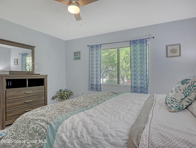 bedroom featuring ceiling fan and multiple windows