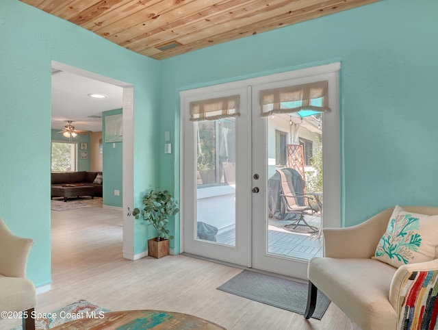 doorway with wood ceiling, baseboards, wood finished floors, and french doors