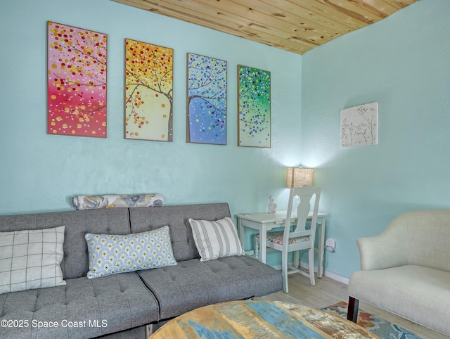 living room with wooden ceiling, baseboards, and wood finished floors