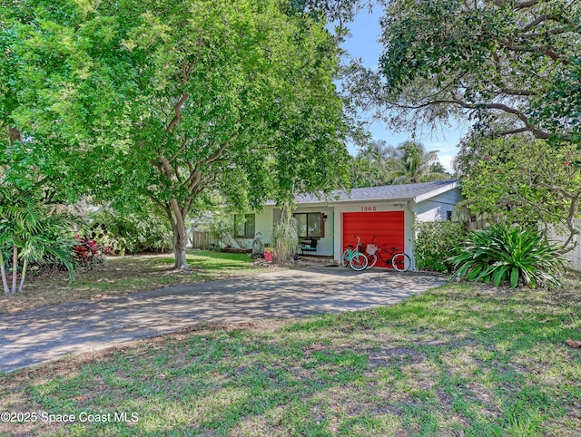 view of front of property with a front yard, driveway, and fence