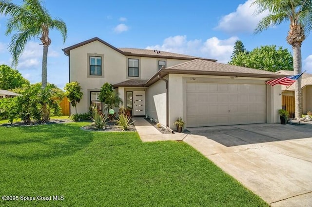 traditional home with driveway, a front yard, an attached garage, and stucco siding