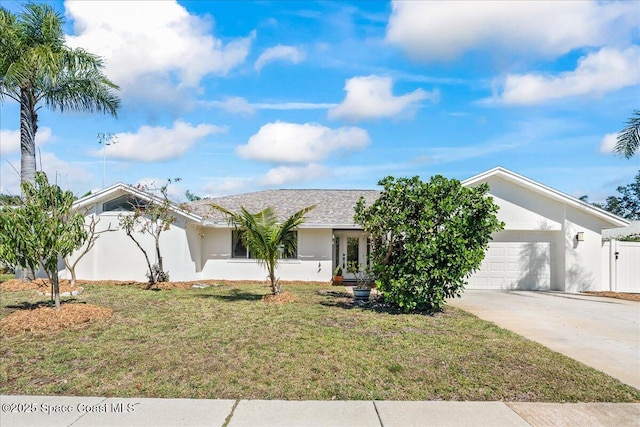 ranch-style home featuring stucco siding, a shingled roof, concrete driveway, a front yard, and a garage