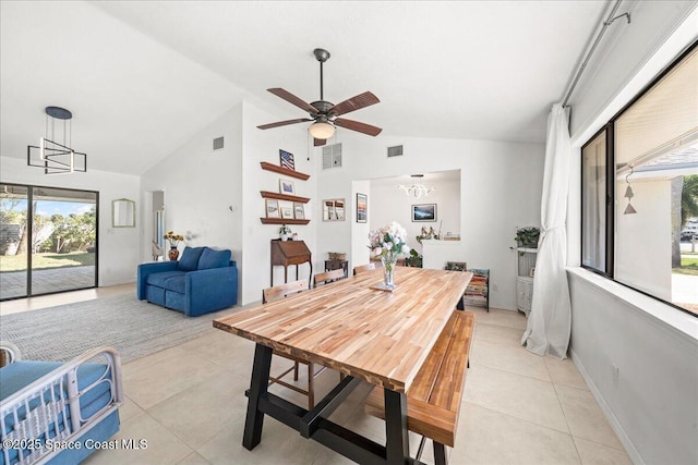 dining area with light tile patterned floors, baseboards, visible vents, and high vaulted ceiling