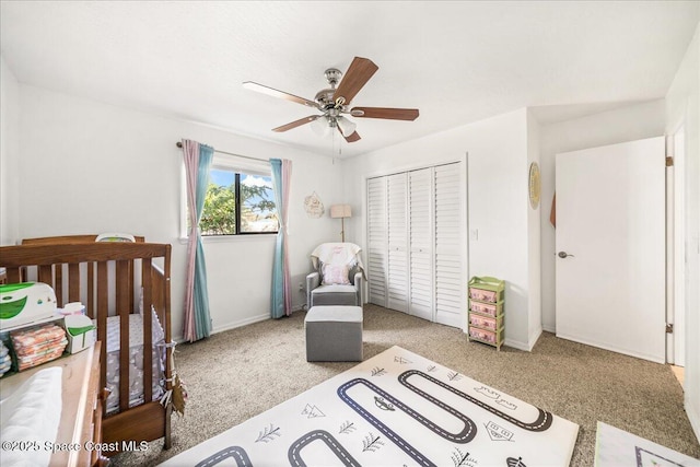 carpeted bedroom with a closet, a ceiling fan, and baseboards