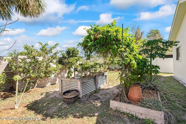 view of yard with a fenced backyard and a vegetable garden