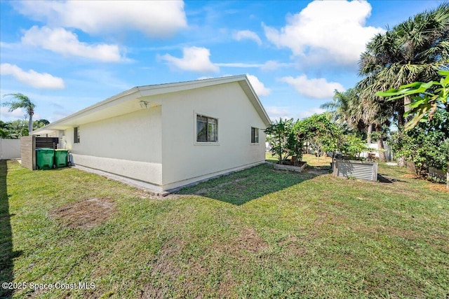 view of home's exterior with a yard and stucco siding