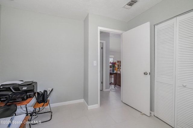 office space featuring baseboards and visible vents