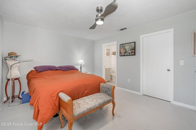 bedroom with a textured ceiling, connected bathroom, a ceiling fan, visible vents, and baseboards