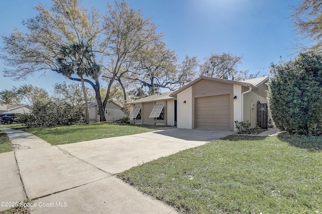 view of front of house featuring driveway, an attached garage, a front yard, and stucco siding