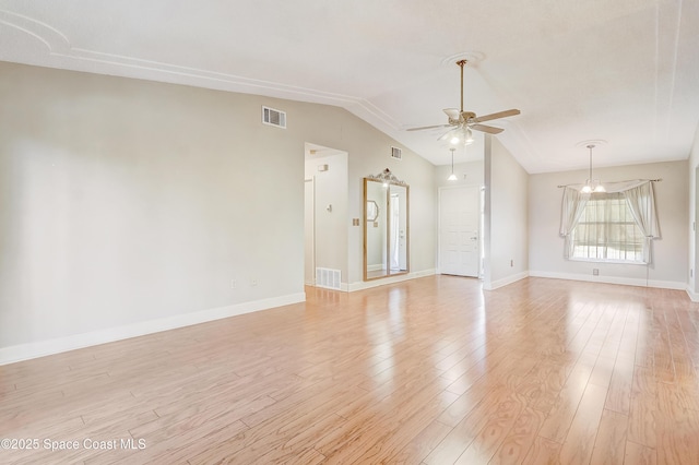 empty room featuring light wood-style floors, lofted ceiling, visible vents, and ceiling fan