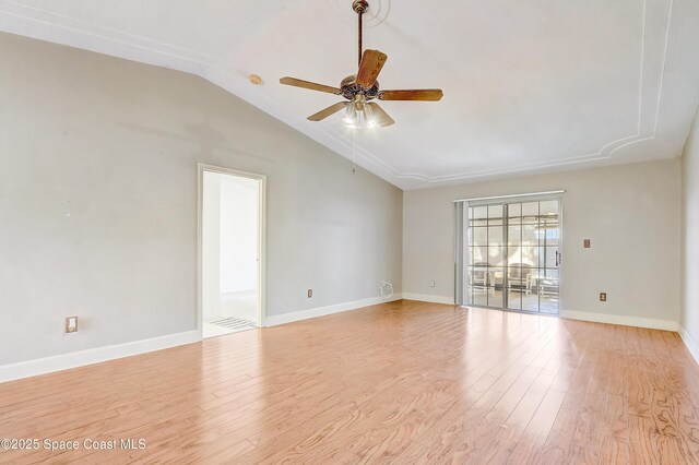 empty room with lofted ceiling, light wood-style flooring, baseboards, and ceiling fan