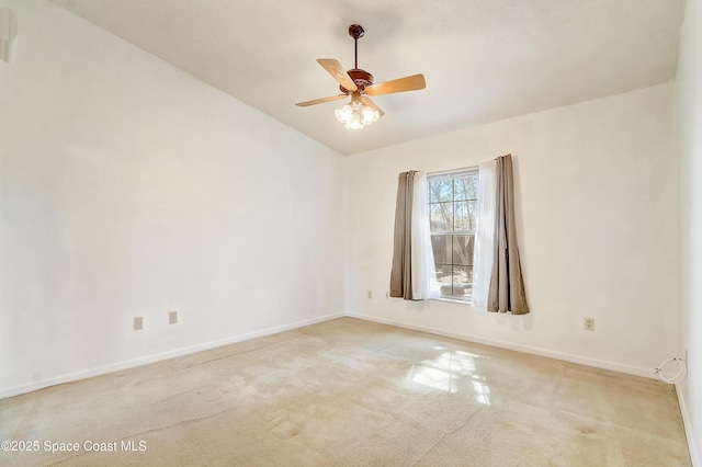 spare room with carpet, ceiling fan, lofted ceiling, and baseboards