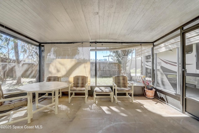 unfurnished sunroom featuring wooden ceiling