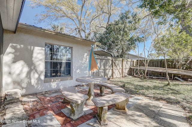 view of patio / terrace featuring fence