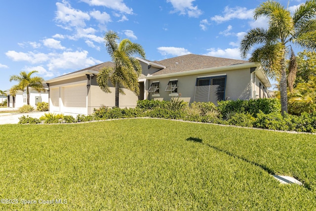 single story home featuring stucco siding, an attached garage, concrete driveway, and a front yard