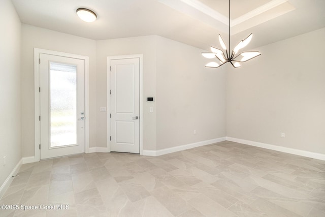 empty room featuring baseboards and a notable chandelier