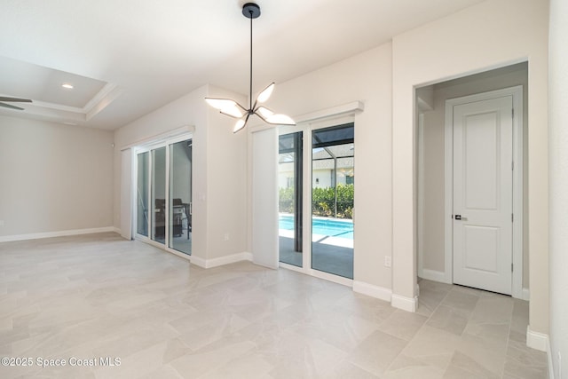 unfurnished room featuring a raised ceiling, recessed lighting, an inviting chandelier, a sunroom, and baseboards