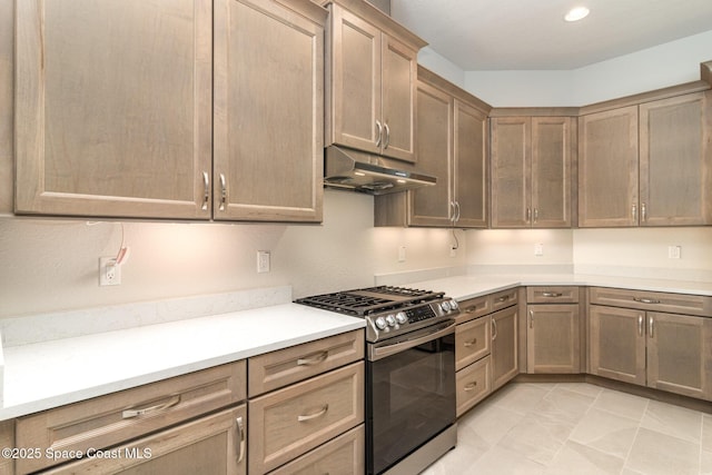 kitchen with gas stove, light tile patterned flooring, recessed lighting, light countertops, and under cabinet range hood