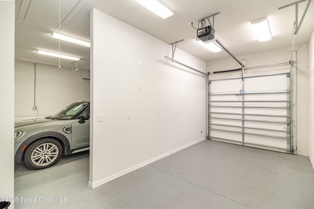 garage featuring a garage door opener and baseboards