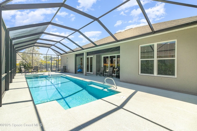 outdoor pool featuring a lanai and a patio area