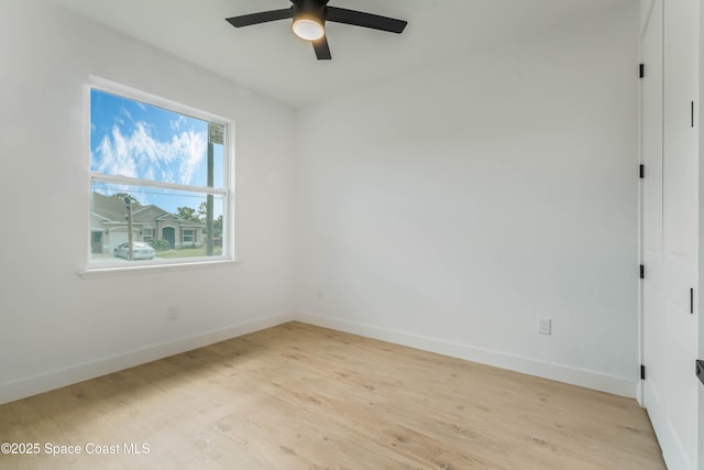 spare room with light wood-style flooring, baseboards, and ceiling fan