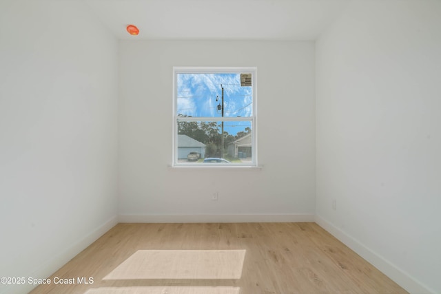 empty room featuring light wood-style flooring and baseboards