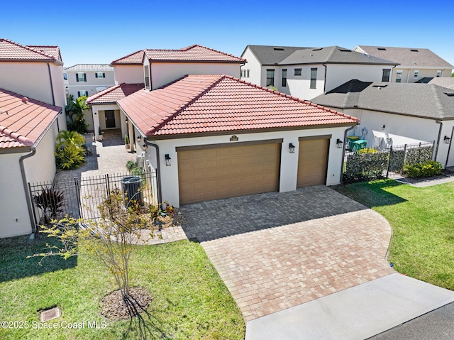 mediterranean / spanish-style house with a front yard, a tiled roof, an attached garage, and fence private yard