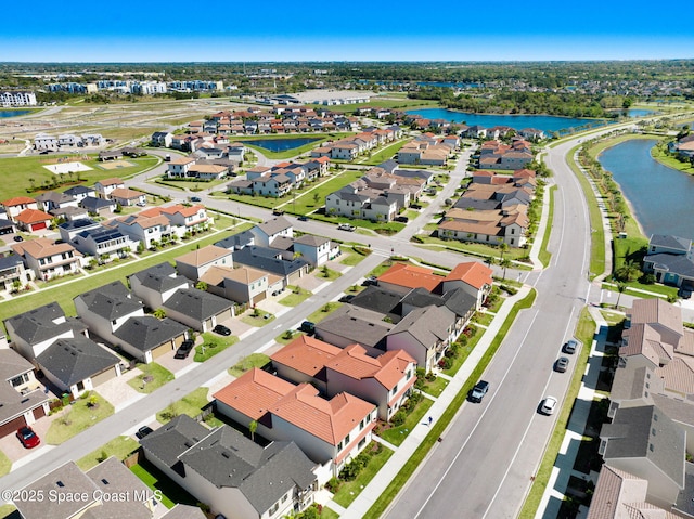 drone / aerial view with a residential view and a water view
