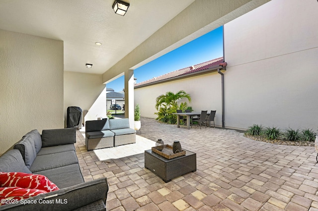 view of patio with an outdoor living space and outdoor dining area