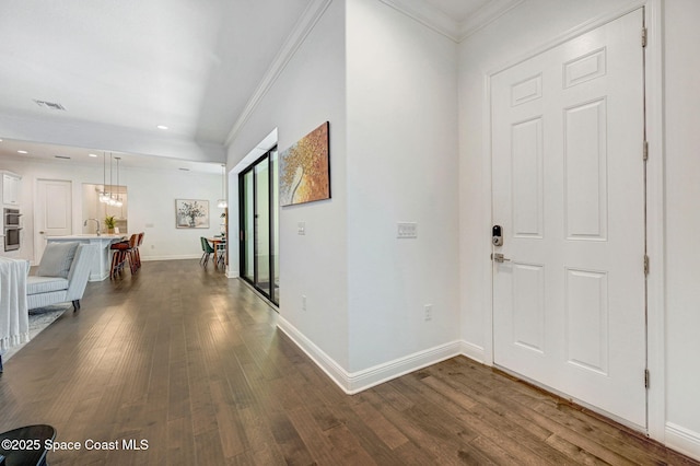 entryway featuring visible vents, baseboards, ornamental molding, recessed lighting, and dark wood-style floors