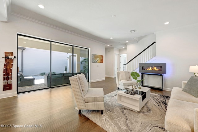 living room featuring stairway, recessed lighting, wood finished floors, and visible vents