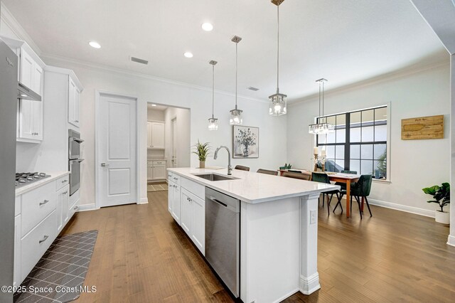kitchen featuring visible vents, a sink, appliances with stainless steel finishes, white cabinets, and light countertops