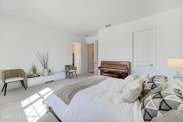 carpeted bedroom featuring visible vents