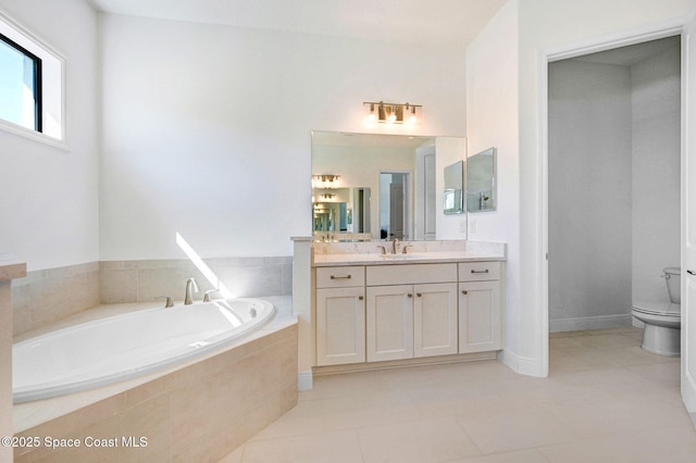 bathroom with vanity, a garden tub, toilet, and tile patterned floors
