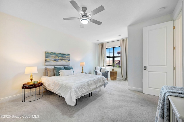 bedroom featuring baseboards, carpet floors, and a ceiling fan