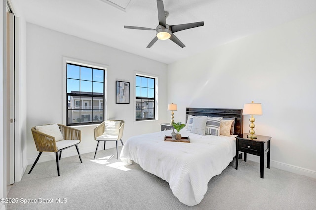 carpeted bedroom featuring a ceiling fan and baseboards