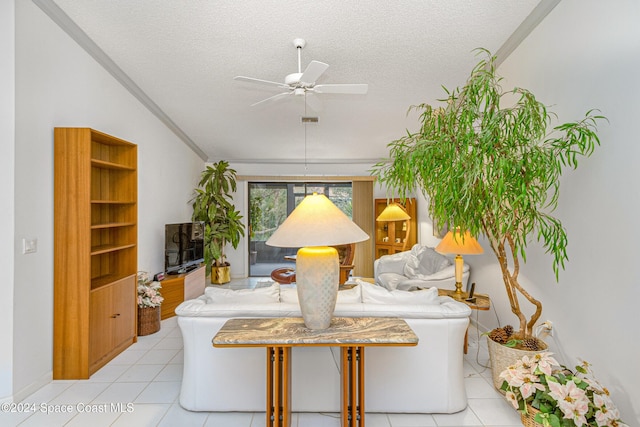 living area with visible vents, ceiling fan, a textured ceiling, and light tile patterned floors