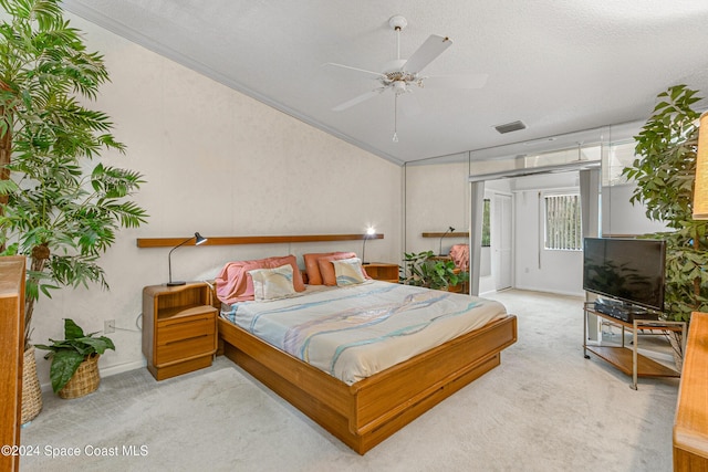 bedroom featuring carpet floors, visible vents, a textured ceiling, and ornamental molding