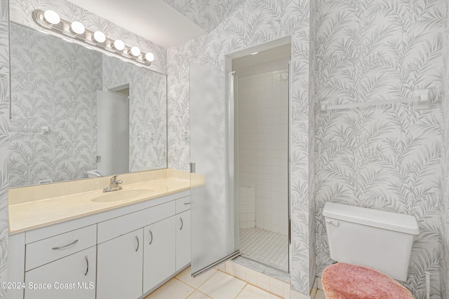 bathroom with tile patterned floors, vanity, toilet, and wallpapered walls