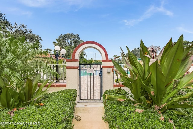 view of gate with a community pool