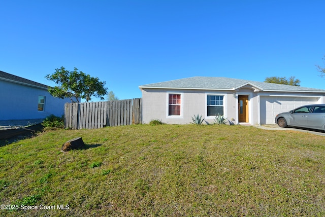 view of side of property with a yard, an attached garage, fence, and stucco siding