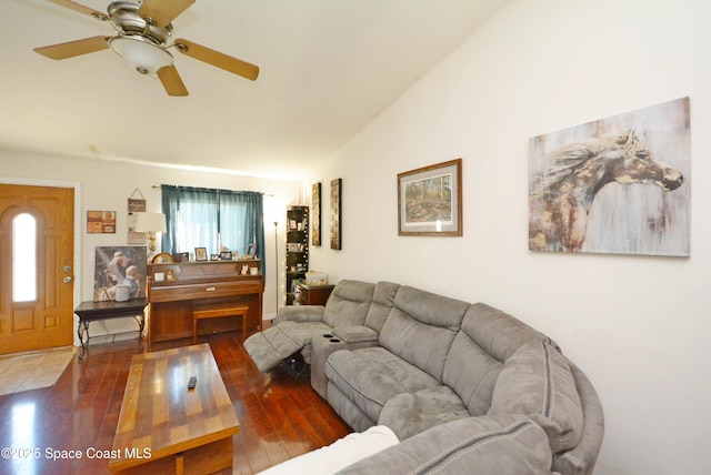 living area with vaulted ceiling, wood finished floors, and a ceiling fan