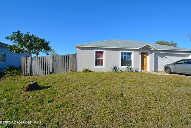 view of property exterior with a yard, an attached garage, and fence