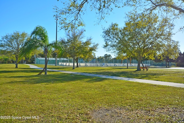 surrounding community featuring fence and a yard