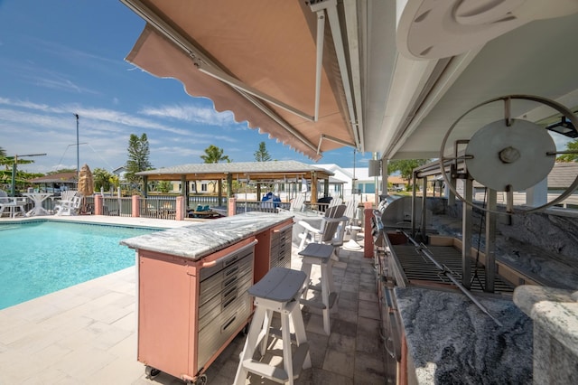 pool with a patio area and fence