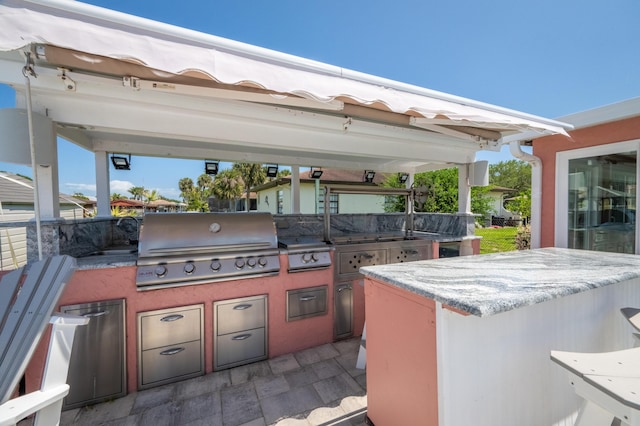 view of patio / terrace with grilling area, exterior kitchen, and a gazebo