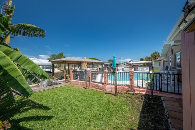 view of yard with a boat dock and fence