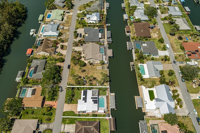 bird's eye view featuring a water view and a residential view